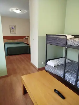 a room with two bunk beds and a table at Hotel Torques in A Coruña