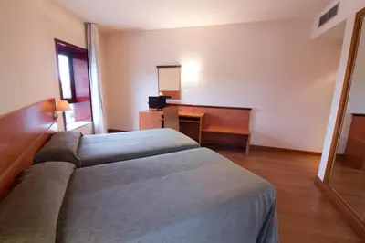 a hotel room with a bed and a desk at Hotel Torques in A Coruña