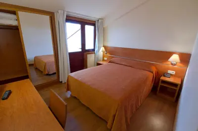 a hotel room with a bed and a mirror at Hotel Torques in A Coruña