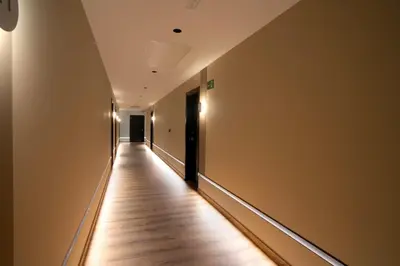 an empty hallway with a wooden floor in a building at HOTEL RIO LEA in Castro de Rey