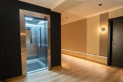 an empty hallway with a glass elevator in a building at HOTEL RIO LEA in Castro de Rey