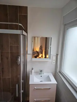 a bathroom with a sink and a shower with a mirror at La Casa del Camino in Santiago de Compostela