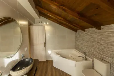 a bathroom with a large bath tub and a sink at Apartamentos Casona del Campo in Navia