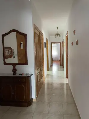 a hallway with a dresser and a mirror on a wall at Piso turístico Baralla in Baralla