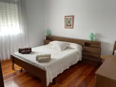 a bedroom with a bed with two towels on it at Piso turístico Baralla in Baralla
