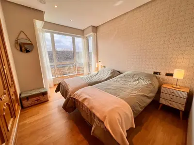 a bedroom with a bed and a large window at Apartamentos San Martín Ourense Centro 1 in Ourense