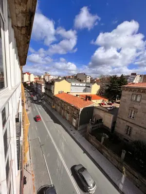 a view of a city street with cars on the road at Apartamentos San Martín Ourense Centro 1 in Ourense