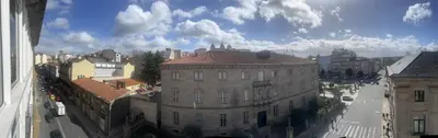 an old building on a street in a city at Apartamentos San Martín Ourense Centro 1 in Ourense