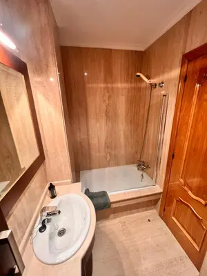 a bathroom with a sink and a bath tub at Apartamentos San Martín Ourense Centro 1 in Ourense