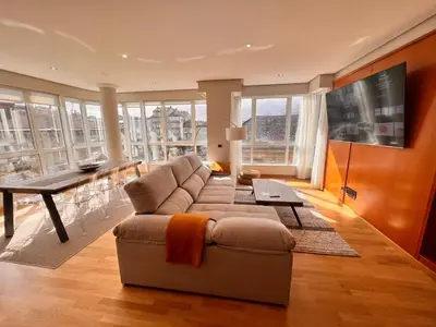 a living room with a couch and a table at Apartamentos San Martín Ourense Centro 1 in Ourense