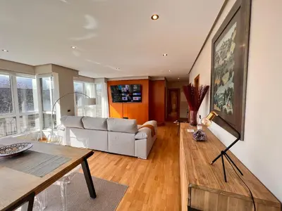 a living room with a couch and a table at Apartamentos San Martín Ourense Centro 1 in Ourense