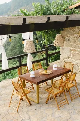 a wooden table and chairs on a patio at Apedeceo Belesar Villa, Ribeira Sacra, Galicia in Chantada