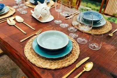 a wooden table with plates and glasses on it at Apedeceo Belesar Villa, Ribeira Sacra, Galicia in Chantada