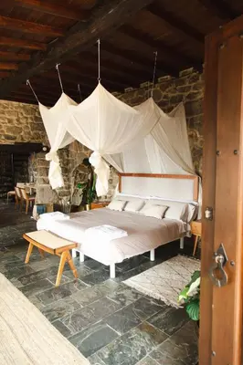 a bedroom with a large bed with a canopy at Apedeceo Belesar Villa, Ribeira Sacra, Galicia in Chantada