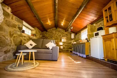 a living room with a couch and a table at A Casiña dos Canastros in Barcia