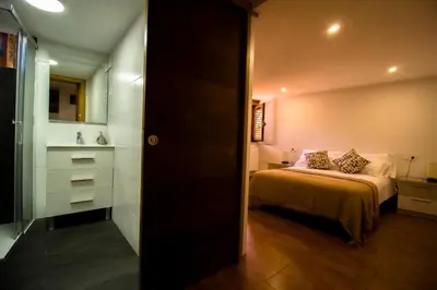a small bedroom with a bed and a bathroom at A Casiña dos Canastros in Barcia