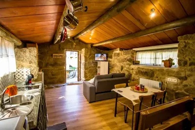 a living room with a couch and a table at A Casiña dos Canastros in Barcia