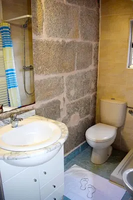 a bathroom with a sink and a toilet at A Beira da Cortella in Melón