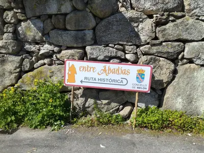 a sign in front of a stone wall at A Beira da Cortella in Melón