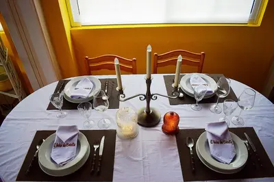 a table with a white table cloth and candles on it at A Beira da Cortella in Melón