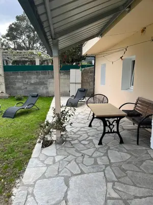 a patio with a table and chairs under a roof at Viviendas uso turístico REME I in Foz
