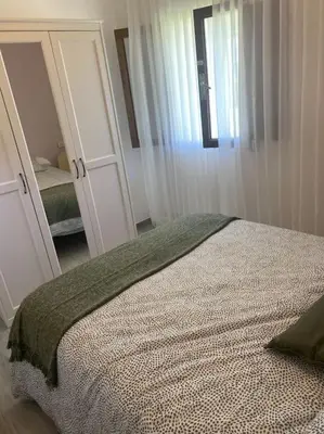 a bedroom with a bed and a large mirror at Viviendas uso turístico REME I in Foz