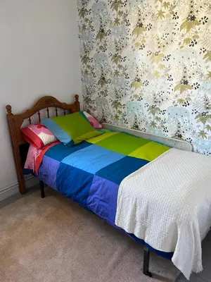a bedroom with a bed with a colorful blanket at Viviendas uso turístico REME I in Foz