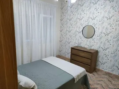 a bedroom with a bed and a mirror and a dresser at Piso centrico en Ribadeo in Ribadeo