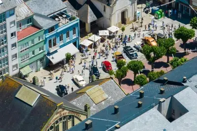 an overhead view of a busy city street with people at Piso centrico en Ribadeo in Ribadeo