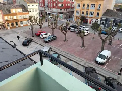 a view of a parking lot with cars parked at Piso centrico en Ribadeo in Ribadeo