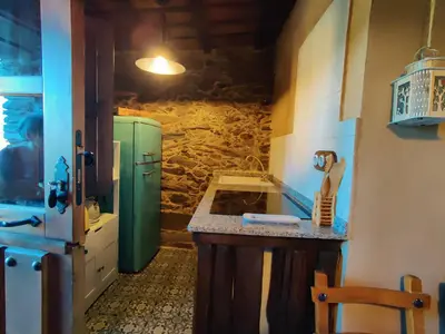 a kitchen with a sink and a green refrigerator at Casita de Florita in Doade