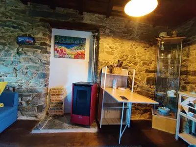 a room with a red refrigerator and a table at Casita de Florita in Doade