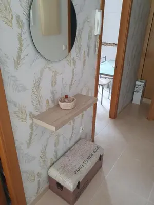a bathroom with a shelf and a mirror and a stool at Miramar in Viveiro