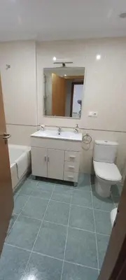 a bathroom with a sink and a toilet and a mirror at Miramar in Viveiro