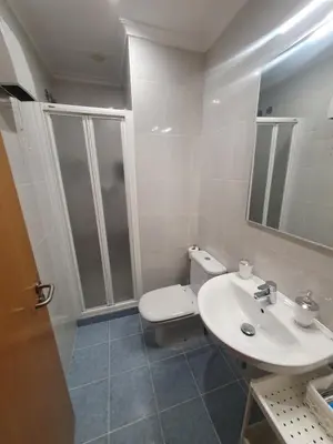 a bathroom with a toilet and a sink and a shower at Miramar in Viveiro