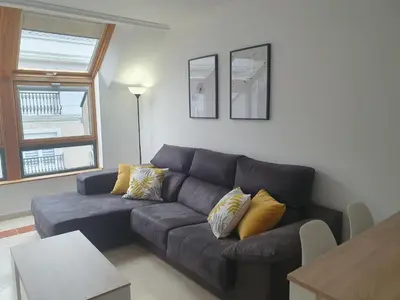 a living room with a couch and a table at Miramar in Viveiro