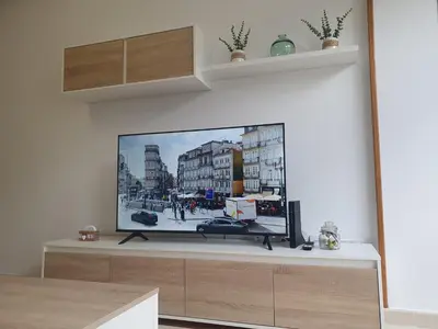 a flat screen tv sitting on top of a entertainment center at Miramar in Viveiro
