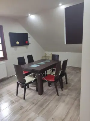 a dining room with a black table and chairs at Casa da Escuela in Caldas de Reis
