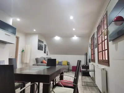 a living room with a table and a couch at Casa da Escuela in Caldas de Reis