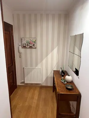 a room with a wooden table and a mirror at PISO OROSO NO CAMIÑO in Sigüeiro