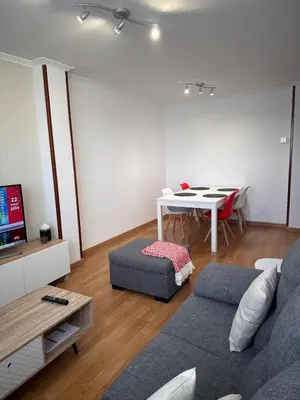 a living room with a couch and a table at PISO OROSO NO CAMIÑO in Sigüeiro