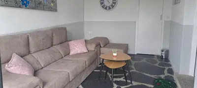 a living room with a couch and a table at Pensión Boavista in Portomarin