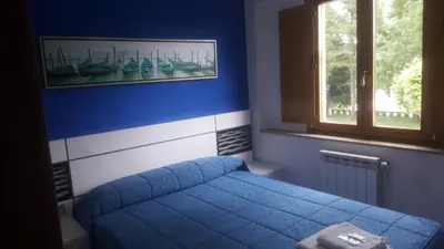 a bedroom with a blue bed and a window at Pensión Boavista in Portomarin