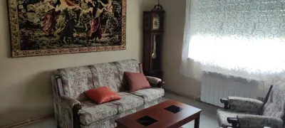 a living room with a couch and a table and a window at Casa Eusebio de Veva in Rinlo