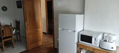 a kitchen with a white refrigerator and a microwave at Casa Eusebio de Veva in Rinlo