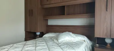 a bedroom with a bed with a wooden headboard at Casa Eusebio de Veva in Rinlo