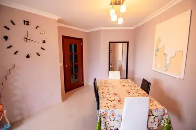 a dining room with a table and a clock on the wall at San Francisco in Viveiro