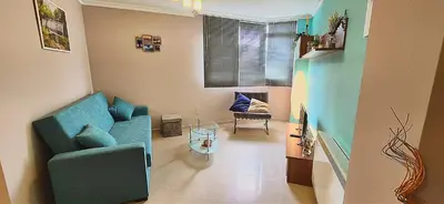 a living room with a blue couch and a chair at San Francisco in Viveiro