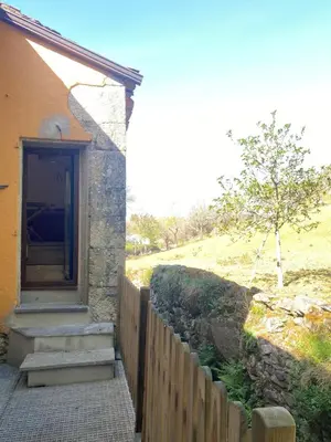 a house with a fence and stairs leading to a door at EL VIEJO MOLINO in Lugo