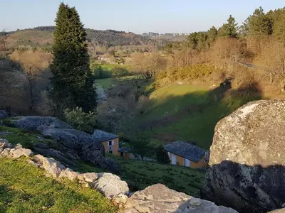 a house on a hill with rocks in a field at EL VIEJO MOLINO in Lugo